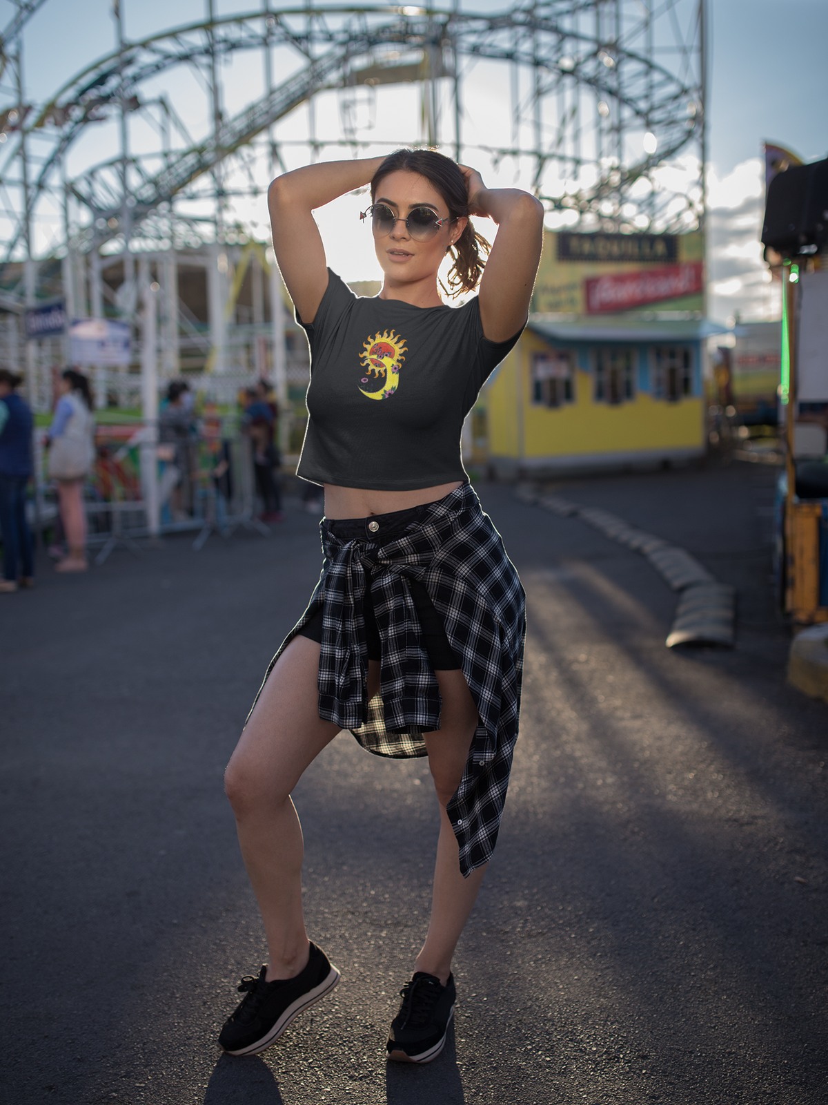 Woman posing in front of an amusement park with a Ferris wheel in the background