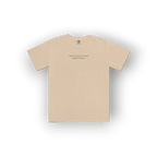 A beige crewneck t-shirt with a small black text graphic printed on the center chest, displayed flat against a white background with a soft drop shadow.