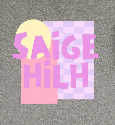 A heather gray short-sleeve t-shirt with a colorful graphic on the back. The graphic features a pastel ice cream cone design with pink and lavender blocks, a yellow circle, and the text 'SAIGE HILH' in pink and purple.