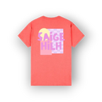 A coral pink short-sleeve t-shirt shown from the back, featuring a colorful graphic print with the text 'SAIGE HILH' in pink and purple over a pastel yellow and purple checkerboard background.