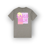 A heather gray short-sleeve t-shirt shown from the back, featuring a colorful graphic print with the text 'SAIGE HILH' in pink over a yellow circle and pink-and-white checkered square.