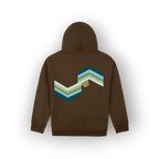 A brown pullover hoodie shown from the back, featuring an original artist designed retro chevron graphic in shades of teal, green, and white, with the text 'SAIGE HILH' printed in yellow.