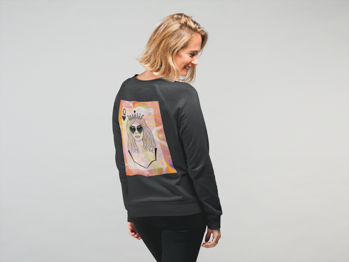A woman wearing a black sweatshirt with a large back graphic of a queen playing card illustration, shown from behind