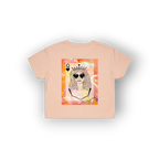 A light peach-pink short-sleeve t-shirt with a colorful graphic print of a cartoon queen character wearing sunglasses and a crown, displayed on a clean white background.