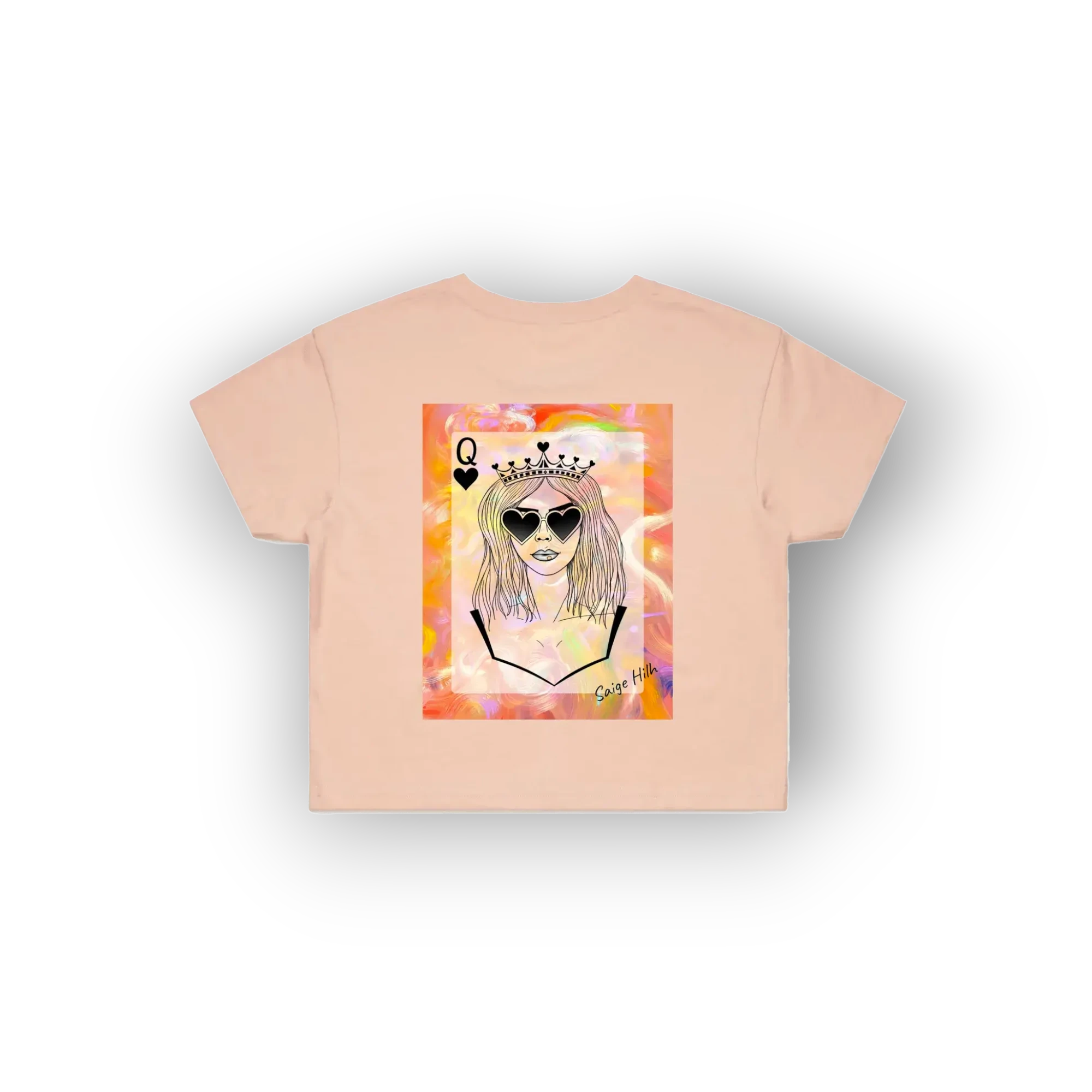 A light peach-pink short-sleeve t-shirt with a colorful graphic print of a cartoon queen character wearing sunglasses and a crown, displayed on a clean white background.
