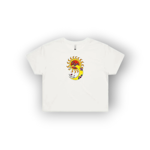 A white short-sleeve crop top t-shirt featuring an original artist designed  colourful graphic print on the chest of a sun, a crescent moon, and a red heart.
