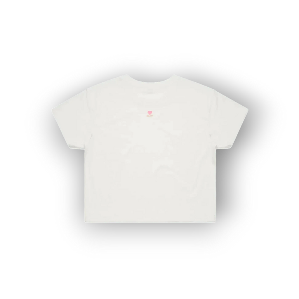 A white short-sleeve crop top t-shirt with a small pink heart and flower graphic on the upper chest, displayed against a clean white background with a soft drop shadow.