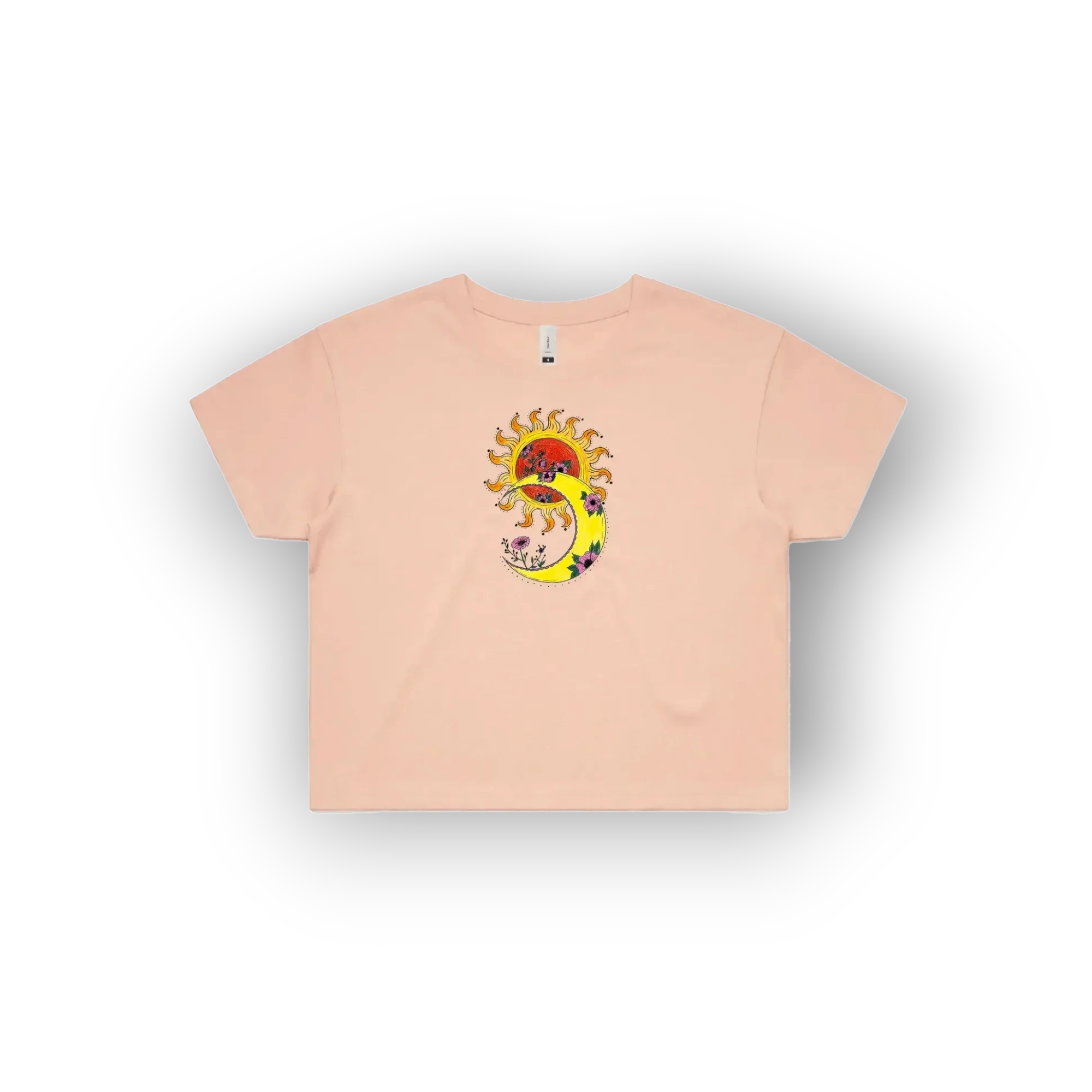A light peach-pink short-sleeve t-shirt with an original artist designed colourful graphic of a sun and crescent moon on the chest, displayed on a clean white background.
