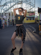 Woman posing in front of an amusement park with a Ferris wheel in the background