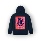 A navy blue hoodie shown from the back, featuring a large square graphic print with a pink and orange floral background and the text 'THIS TOO SHALL PASS' in dark blue lettering.