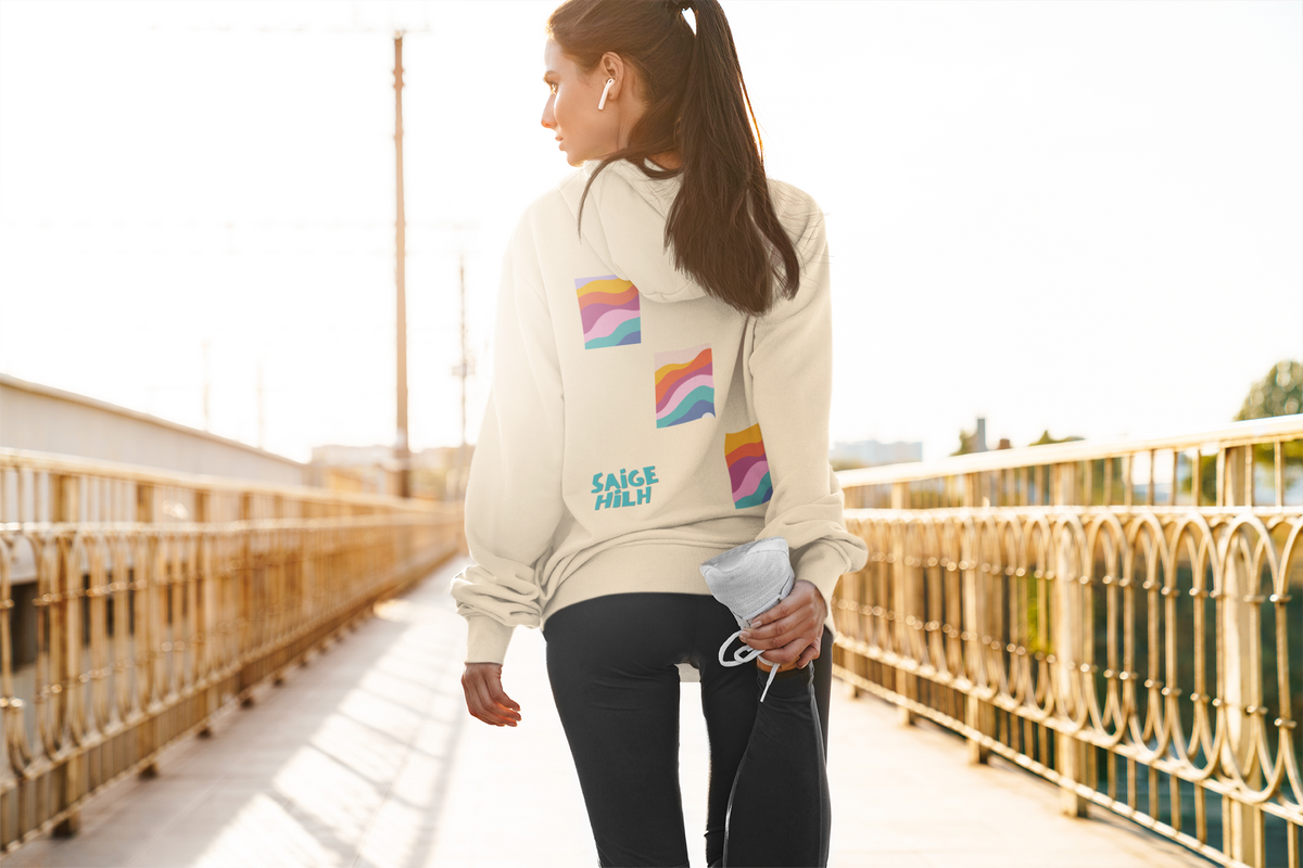 women stretching for a run with a beige hoodie shown from the back, featuring three colourful retro wavy graphic squares and the text 'SAIGE HILH' in teal on the back.